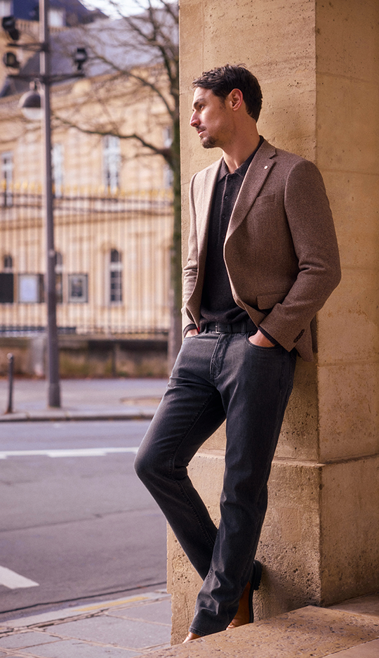 Man in brown blazer and black jeans