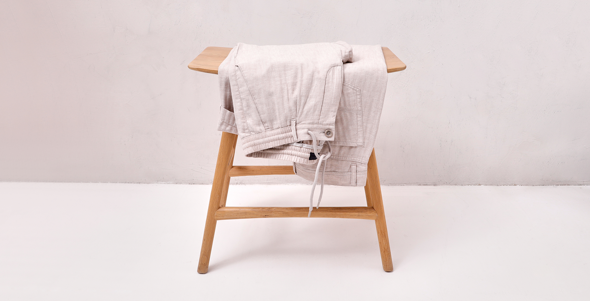Light linen pants on a bamboo seat